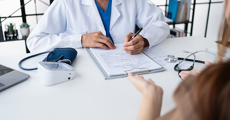 Woman consulting an abortion doctor as her medical records are reviewed